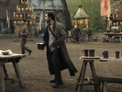 Barney Harris is holding mugs as he is walking.